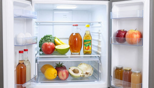 A perfectly organized home refrigerator with drinks neatly arranged on shelves and in the door, showcasing an efficient system.